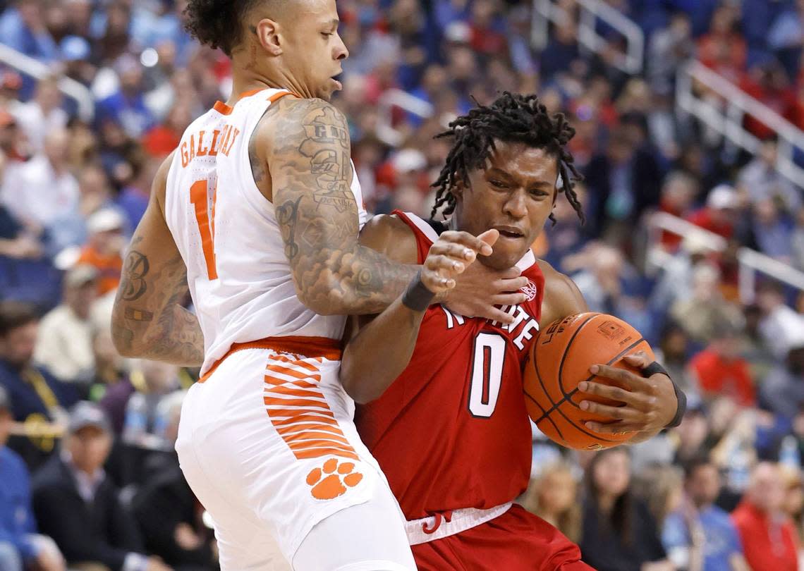 N.C. State’s Terquavion Smith (0) is fouled by Clemson’s Brevin Galloway (11) during the first half of N.C. State’s game against Clemson in the quarterfinals of the ACC Men’s Basketball Tournament in Greensboro, N.C., Thursday, March 9, 2023.