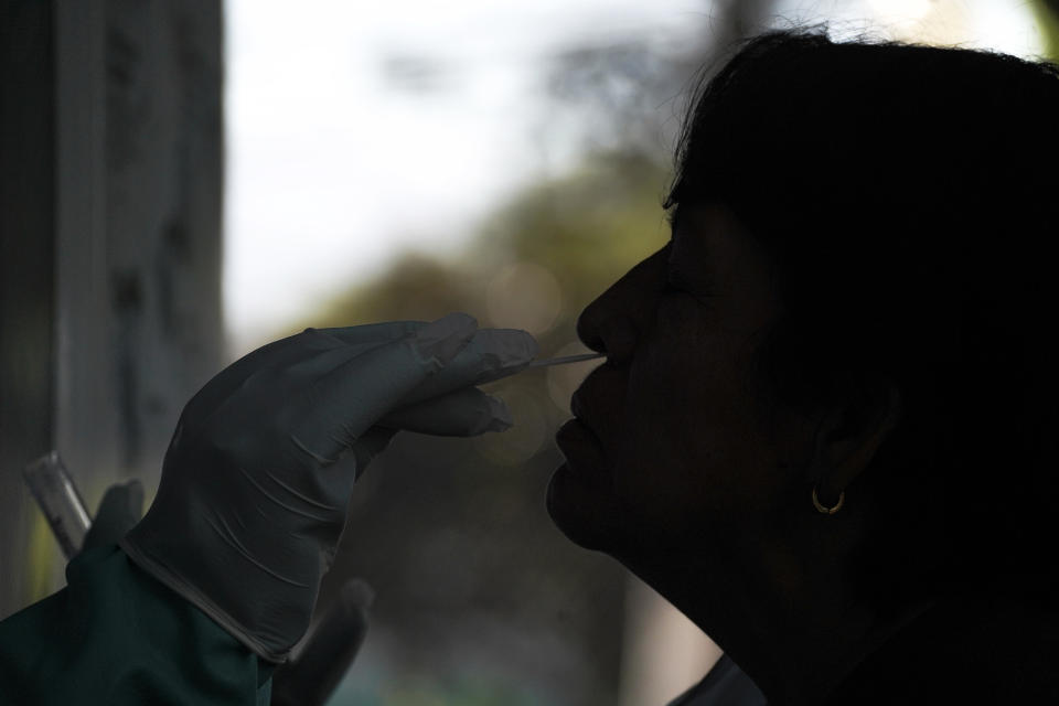 A health worker inserts a swab into a patient's nose at a COVID-19 testing center. / Credit: Camilo Freedman/APHOTOGRAFIA/Getty Images