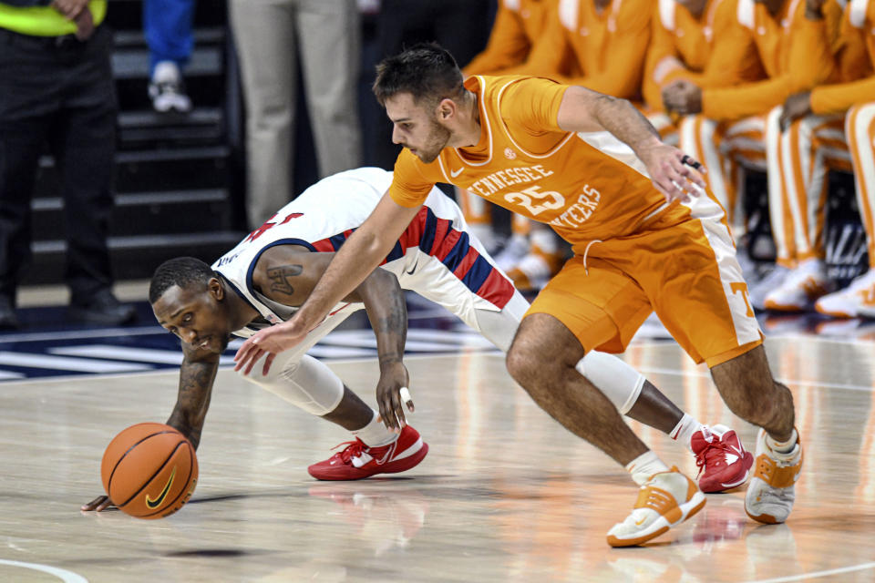 Mississippi guard Tye Fagan (14) and Tennessee guard Santiago Vescovi (25) go for a loose ball in the first half in an NCAA college basketball game, Wednesday, Dec. 28, 2022 in Oxford, Miss. (AP Photo/Bruce Newman)