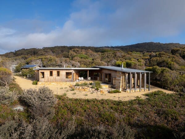 The remote off-grid residence offers a peaceful oasis, all while being conveniently located just a 15-minute drive from local shops and cafes.