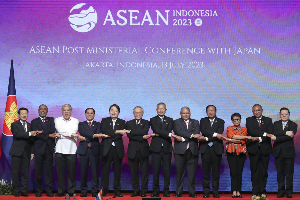 From left to right, Laotian Foreign Minister Saleumxay Kommasith, Malaysian Foreign Minister Zambry Abdul Kadir, Philippine's Foreign Secretary Enrique Manalo, Vietnam's Foreign Minister Bui Thanh Son, Japan's Foreign Minister Yoshimasa Hayashi, Thailand's Foreign Minister Don Pramudwinai, Singapore's Foreign Minister Vivian Balakrishnan, Brunei's Second Minister of Foreign Affair Erywan Yusof, Cambodia's Foreign Minister Prak Sokhonn, Indonesian Foreign Minister Retno Marsudi, East Timor's Foreign Minister Bendito Freitas and ASEAN Secretary General Kao Kim Hourn hold hands for a group photo during the ASEAN Post Ministerial Conference with Japan at the Association of Southeast Asian Nations (ASEAN) Foreign Ministers' Meeting in Jakarta, Indonesia, Thursday, July 13, 2023. (Bagus Indahono/Pool Photo via AP)