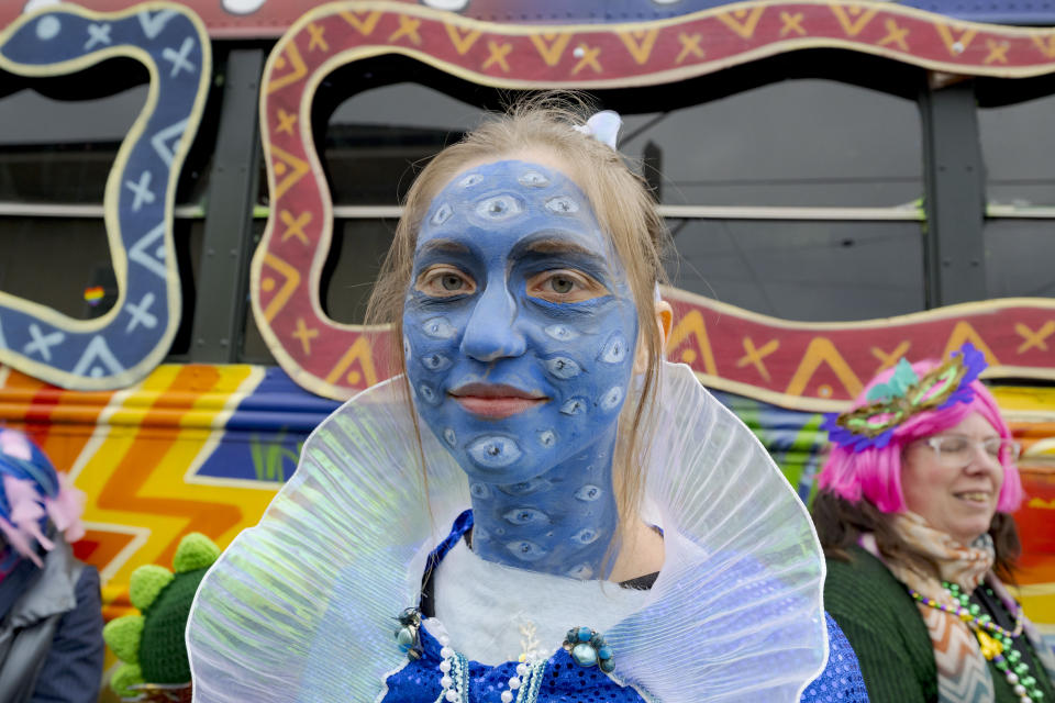 People walk in costumes during the Society of Saint Anne parade through Bywater and Marigny neighborhoods on Mardi Gras Day in New Orleans, Tuesday, Feb. 13, 2024. (AP Photo/Matthew Hinton)