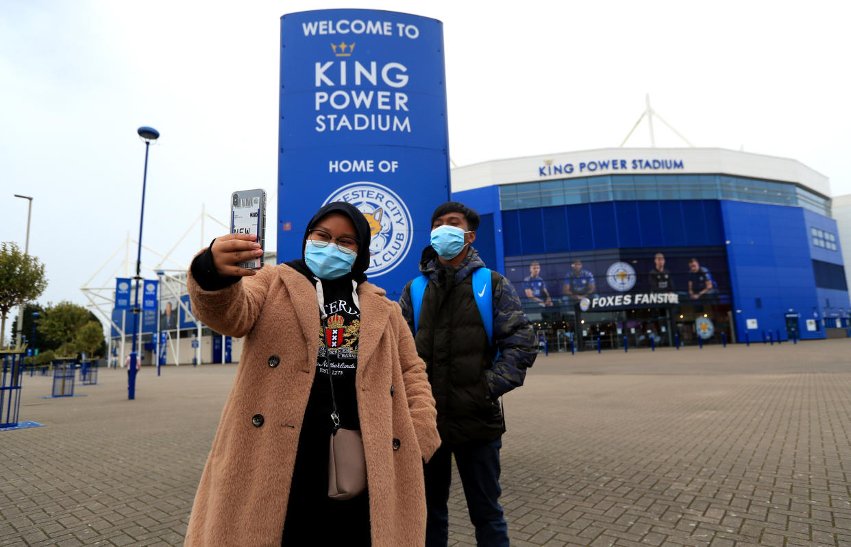 Two people taking a selfie outside the King Power Stadium, home of Leicester City. Premier League clubs will gather via conference call on Thursday morning to discuss fixtures and finances amid the coronavirus pandemic. Top-flight action is suspended until April 4 at the earliest, and measures around social distancing mean no clubs will be present in person for the meeting. (Photo by Mike Egerton/PA Images via Getty Images)