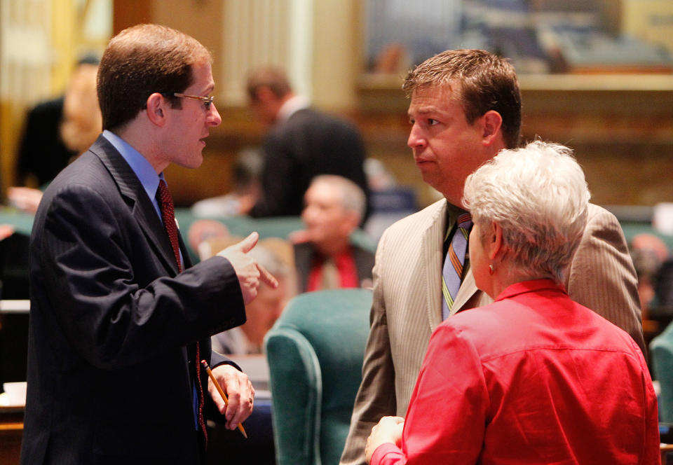 House Minority Leader Mark Ferrandino, left, D-Denver, talks with House Speaker Frank McNulty, center, R-Highlands Ranch, and Rep. Lois Court, D-Denver, at the Capitol in Denver on Wednesday, May 9, 2012. Wednesday was the last day of the session. (AP Photo/Ed Andrieski)