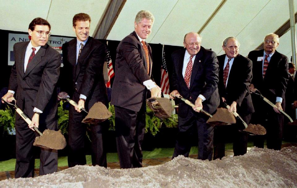 Secretary of Transportation Federico Pena, Northwest Airlines Chairman Al Checchi, President Clinton, Wayne County Executive Ed McNamara, Sen. Carl Levin (D-Mich.) and Dingell&nbsp;turn ceremonial shovels of dirt to break ground for a $1.6 billion expansion of the Detroit Metro Airport.