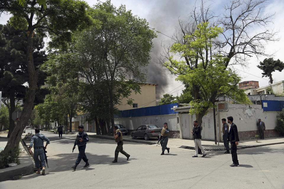 Afghan security personnel arrive near the site of an explosion in Kabul, Afghanistan, Wednesday, May 8, 2019. The Taliban attacked the offices of an international NGO, called Counterpart International, in the Afghan capital, setting off a huge explosion and battling Afghan security forces in an assault that wounded at least nine people, officials said. (AP Photo/Rahmat Gul)