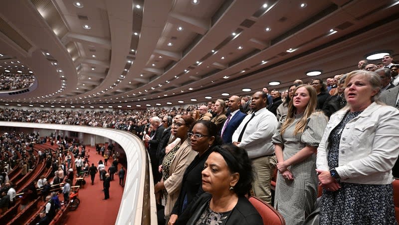Members of the audience stand and join with the Tabernacle Choir during a song at the Conference Center in Salt Lake City on Saturday, April 6, 2024.