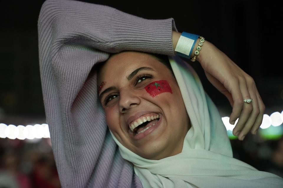 FILE - A Moroccan fan celebrates after their team scored the first goal during a World Cup quarter-final soccer match between Portugal and Morocco, at the Dubai Media City, in Dubai, United Arab Emirates, Saturday, Dec. 10, 2022. (AP Photo/Kamran Jebreili, File)