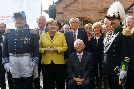 German Chancellor Angela Merkel, European Commission President Jean-Claude Juncker and German Finance Minister Wolfgang Schaeuble pose for a photograph as they attend a gala reception organised by the CDU in Baden-Wuerttemberg to mark Schaeuble's 75th birthday in Offenburg, Germany, September 18, 2017. REUTERS/Kai Pfaffenbach