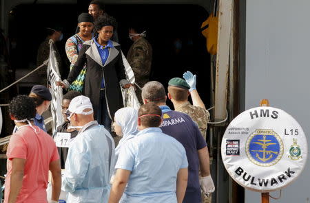 Migrants disembark from British warship HMS Bulwark at Catania harbour, Italy, May 14, 2015. REUTERS/Antonio Parrinello