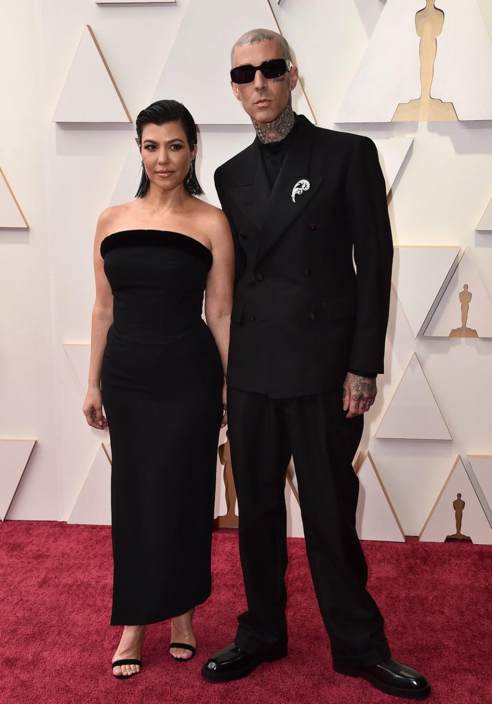 Kourtney Kardashian and Travis Barker at the 2022 Oscar red carpet. - Credit: AP