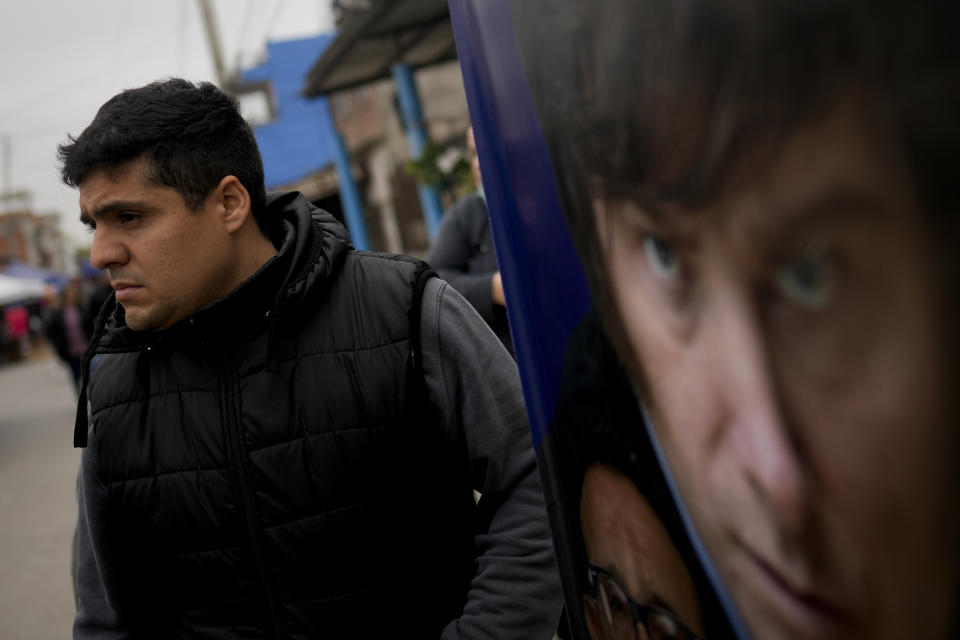 Rubén Dávalos, follower of presidential hopeful Javier Milei, stands in the street promoting his candidate in the Fiorito neighborhood of Buenos Aires, Argentina, Saturday, Sept. 23, 2023. Milei, a right-wing populist who admires Donald Trump and made a name for himself by shouting against Argentina's “political caste” on television, finds himself the front-runner for this month's presidential election. (AP Photo/Natacha Pisarenko)