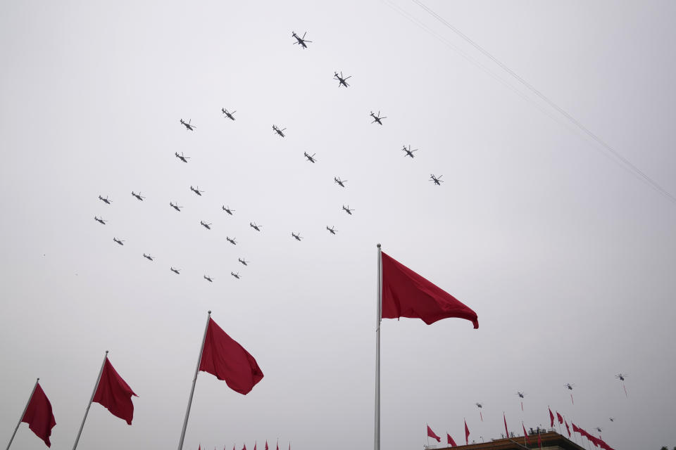 Helicopters fly over Chinese flags at Tiananmen Square in the formation of "100" during a ceremony to mark the 100th anniversary of the founding of the ruling Chinese Communist Party at Tiananmen Gate in Beijing Thursday, July 1, 2021. (AP Photo/Ng Han Guan)