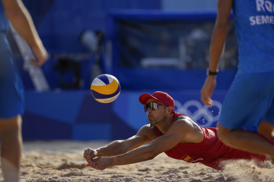 Pablo Herrera Allepuz, of Spain, dives for the ball during a men's beach volleyball match against of the Russian Olympic Committee, at the 2020 Summer Olympics, Saturday, July 24, 2021, in Tokyo, Japan.(AP Photo/Petros Giannakouris)