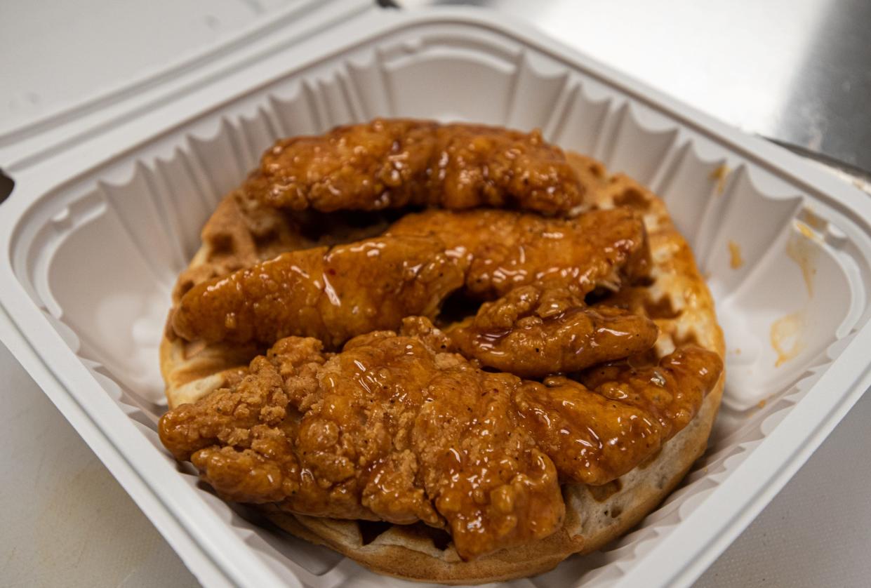 Elsa's Chicken & Waffles' hot honey tenders and waffle plate is seen Wednesday, May 3, 2023. The new restaurant opened March 22 near Jolly and Waverly roads in Lansing.