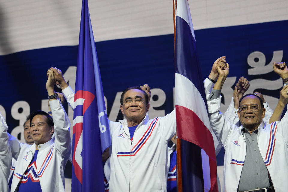 Thailand's Prime Minister Prayuth Chan-ocha , center, gestures as he officially announces joining the United Thai Nation Party as a newly-established party's candidate in Bangkok, Thailand, Monday, Jan. 9, 2023. Prayuth, who first came to power as army chief leading a coup in 2014, became prime minister in an elected government in 2019 as the candidate of the military-backed Palang Pracharath Party, but has split with his former colleagues to become the candidate for Ruam Thai Sang Chart, or United Thai Nation Party, in this year's not-yet-scheduled general election. (AP Photo/Sakchai Lalit)