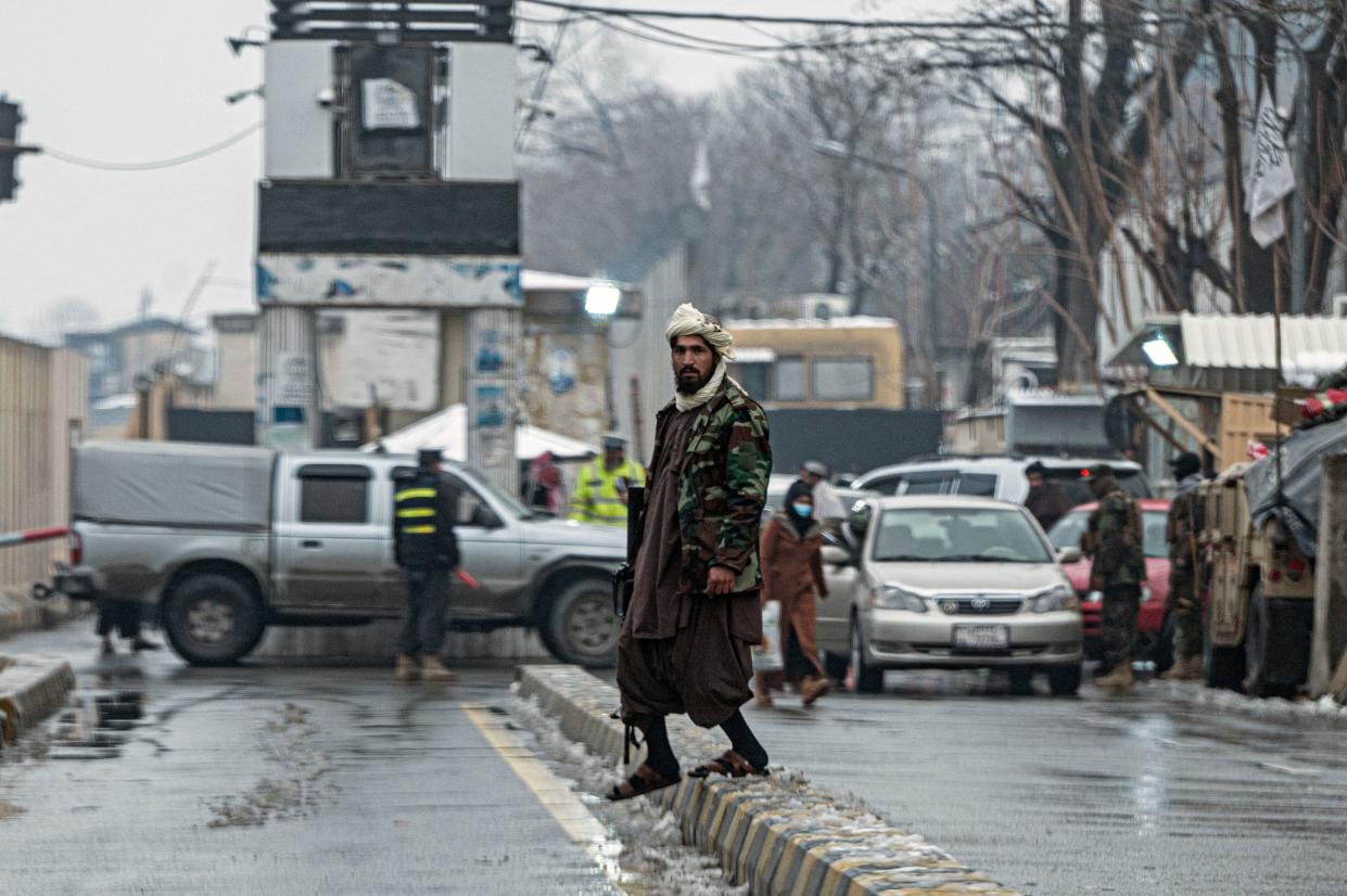A member of the Taliban security forces stands guard on a blocked road after a suicide blast near Afghanistan's foreign ministry, at the Zanbaq Square in Kabul, January 11, 2023. / Credit: WAKIL KOHSAR/AFP/Getty
