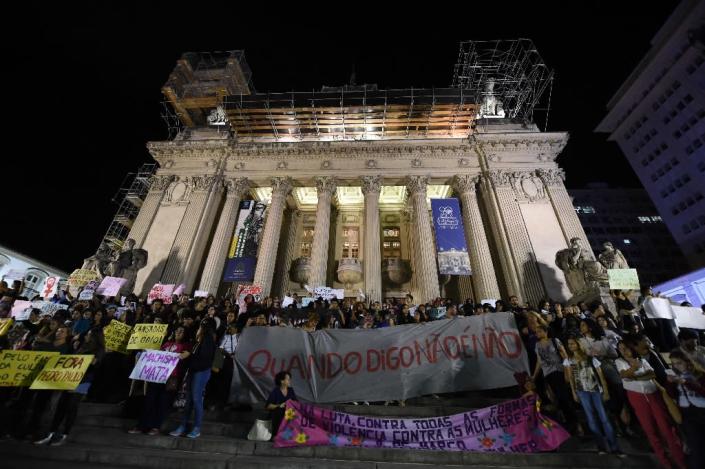 Brazilians protest in front of the Legislative Assembly of Rio de Janeiro (ALERJ) on May 27, 2016, against a gang-rape of a 16-year-old girl (AFP Photo/Vanderlei Almeida)