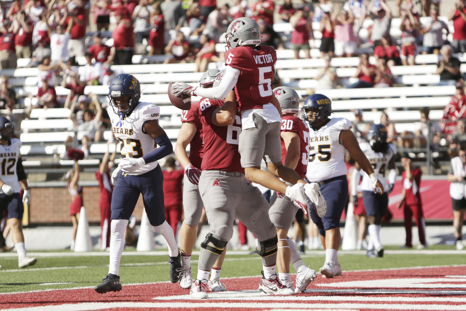 Washington State wide receiver Lincoln Victor (5) celebrates his touchdown with offensive lineman Ma'ake Fifita (66) during the first half of an NCAA college football game against Northern Colorado, Saturday, Sept. 16, 2023, in Pullman, Wash. (AP Photo/Young Kwak)