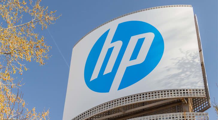 HP (HPQ) sign with blue sky and autumn leaves as backdrop