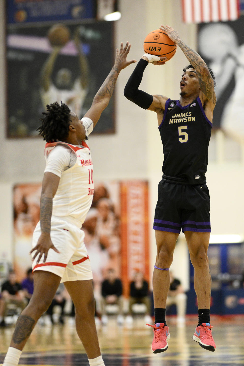 James Madison guard Terrence Edwards (5) shoots against Morgan State forward Will Thomas, left, during the first half of an NCAA college basketball game, Friday, Dec. 22, 2023, in Baltimore. (AP Photo/Nick Wass)