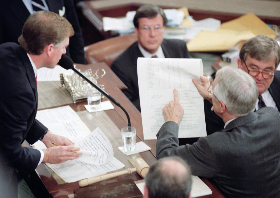 Kentucky Sen. Wendell Ford (right) and Vice President Dan Quayle look over a tally sheet of the Electoral College during a joint session of Congress   on  Jan 6,1993.  