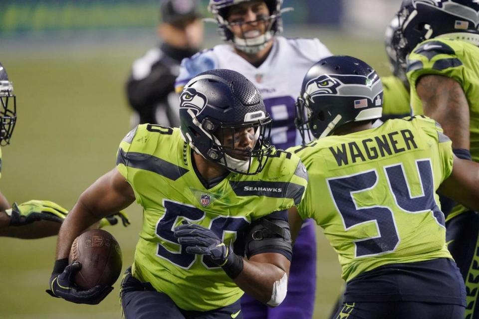 Seattle Seahawks’ K.J. Wright runs with the ball after recovering a Minnesota Vikings fumble during the second half of an NFL football game, Sunday, Oct. 11, 2020, in Seattle. (AP Photo/Ted S. Warren)