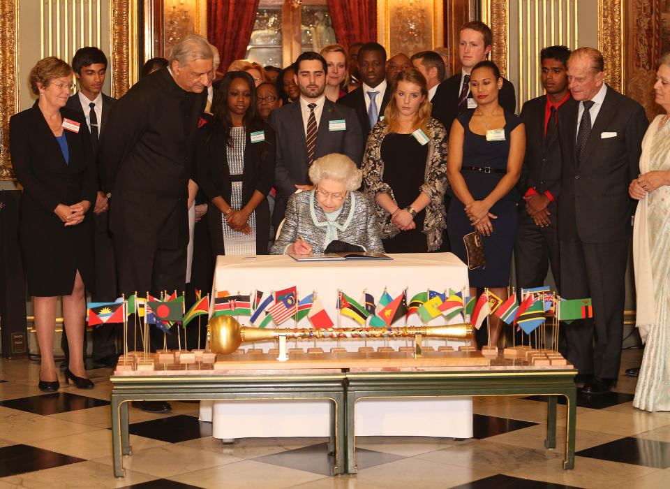 Britain's Queen Elizabeth II, Head of the Commonwealth signs the Commonwealth Charter at a reception at Marlborough House, London, Monday March 11, 2013. The Charter is an historic document which brings together, for the first time in the associations 64-year history, key declarations on Commonwealth principles. (AP Photo/PA, Philip Toscano) UNITED KINGDOM OUT NO SALES NO ARCHIVE