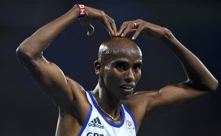 2016 Rio Olympics - Athletics - Final - Men's 10,000m Final - Olympic Stadium - Rio de Janeiro, Brazil - 13/08/2016. Mo Farah (GBR) of Britain celebrates after winning the race REUTERS/Dylan Martinez