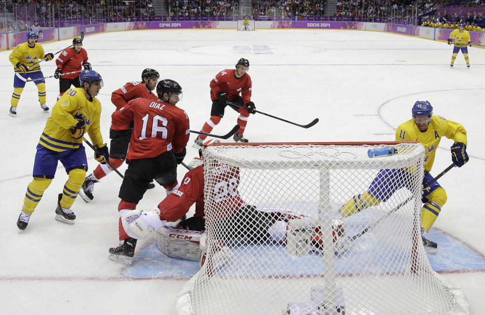 Sweden forward Daniel Alfredsson (11) scores against Switzerland in the third period of a men's ice hockey game at the 2014 Winter Olympics, Friday, Feb. 14, 2014, in Sochi, Russia. Sweden won 1-0. (AP Photo/Mark Humphrey )