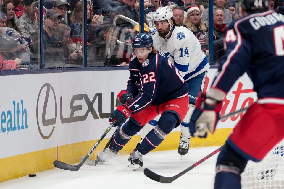 Oct 14, 2022; Columbus, Ohio, USA;  Columbus Blue Jackets defenseman Jake Bean (22) moves the puck around Tampa Bay Lightning left wing Pat Maroon (14) during the second period of the NHL hockey game at Nationwide Arena. Mandatory Credit: Adam Cairns-The Columbus Dispatch