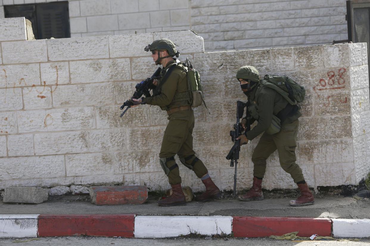 Israeli soldiers conduct a search for suspects o in the shooting attack near Ofra: (AP Photo/Majdi Mohammed)