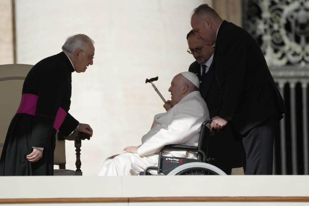 Pope Francis talks with Monsignor Leonardo Sapienza during his weekly general audience in St. Peter's Square, at the Vatican, Wednesday, March 29, 2023. (AP Photo/Alessandra Tarantino)