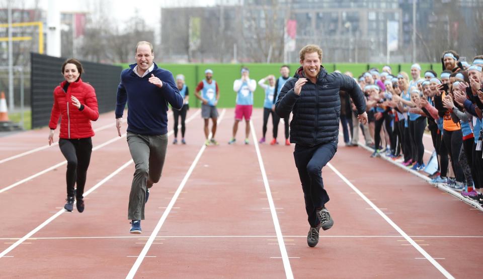 Britain's Prince William, second left, Kate, the Duchess of Cambridge, background left, and Prince Harry take part in a relay race, during a training event to promote the charity Heads Together, at the Queen Elizabeth II Park in London, Sunday, Feb. 5, 2017. (AP Photo/Alastair Grant, Pool)