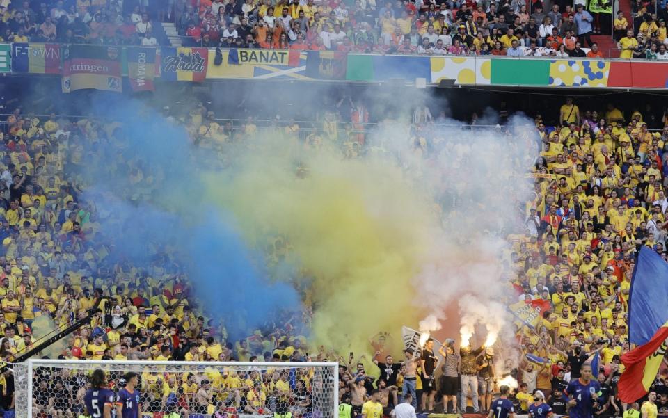 Supporters of Romania light flares during the UEFA EURO 2024 Round of 16 soccer match between Romania and Netherlands, in Munich, Germany, 02 July 2024.