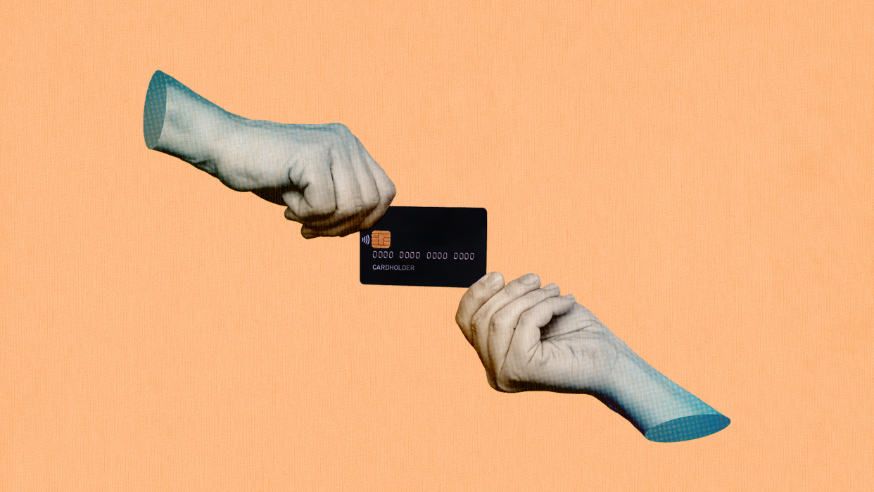 "photo of two hands holding opposite ends of a credit card"