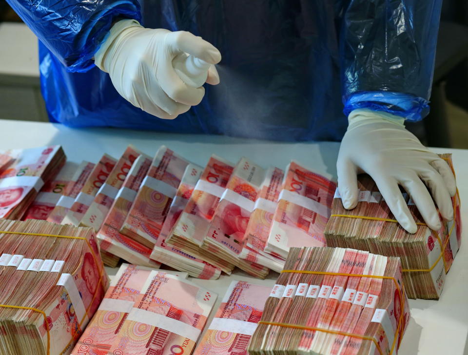 SUINING, CHINA - FEBRUARY 26 2020: A clerk disinfects banknotes in the headquarters of Suining Bank in Suining city in southwest China's Sichuan province Wednesday, Feb. 26, 2020. China's central bank has ordered banks to disinfect cash and destroy cash received from hospitals to curb the spread of the coronavirus.- PHOTOGRAPH BY Feature China / Barcroft Studios / Future Publishing (Photo credit should read Feature China/Barcroft Media via Getty Images)