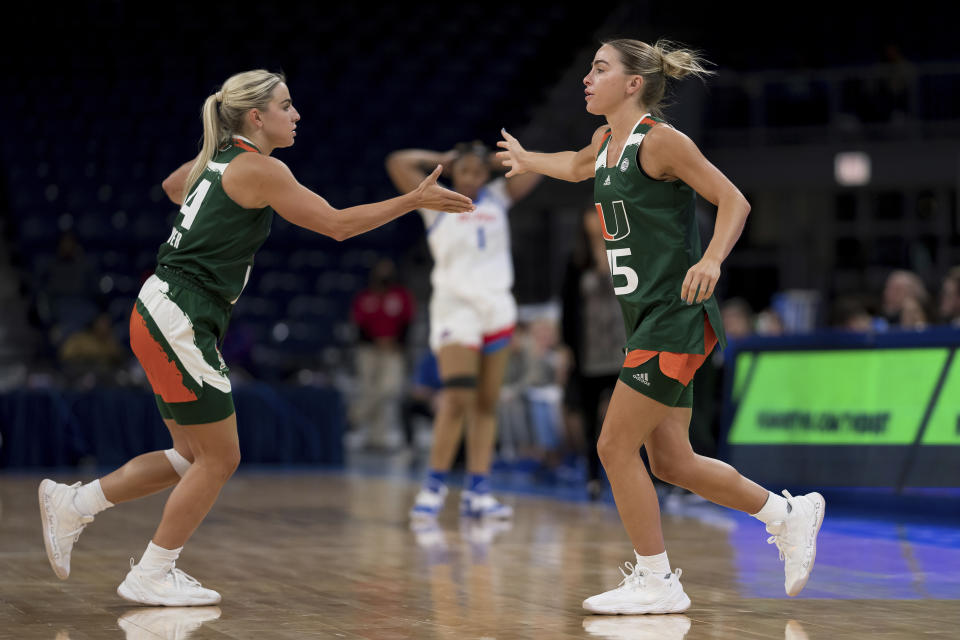 FILE - Miami NCAA college basketball guards and sisters, Haley and Hanna Cavinder, are shown during a game against DePaul on Sunday, Nov. 20, 2022, in Chicago. Haley and Hanna Cavinder are going to the NCAA Tournament. The Miami guards are perhaps the faces of the NIL movement in college athletics. And they have a massive following on social media. (AP Photo/Matt Dirksen, File)