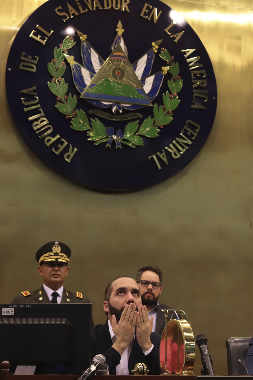 El Salvador's President Nayib Bukele prays after his arrival at congress in San Salvador in San Salvador, El Salvador, Sunday, Feb. 9, 2020. Bukele has called on supporters to converge around the country's parliament after legislators refused to gather to vote on a $109 million loan to better equip the country's security forces. Top commanders of the country's police and military have expressed allegiance to the president during the standoff, while positioning security forces in and around the legislative building. (AP Photo/Salvador Melendez)