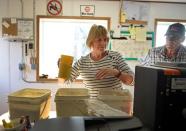 Vannessa and Paul Kummer evaluate soybeans near Colfax, North Dakota