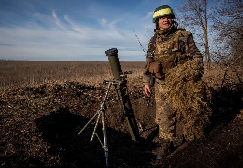 A Ukrainian serviceman prepares a mortar to shoot at a frontline in Donetsk Region
