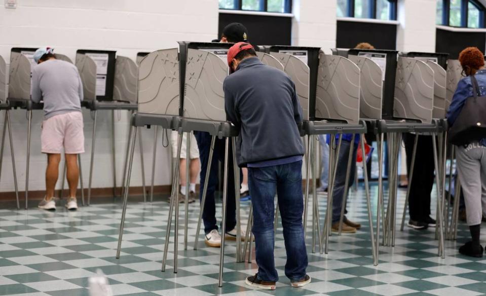 Voters cast their ballot at the early voting site at the Cary Senior Center in Cary, N.C., on Friday, Oct. 28, 2022.