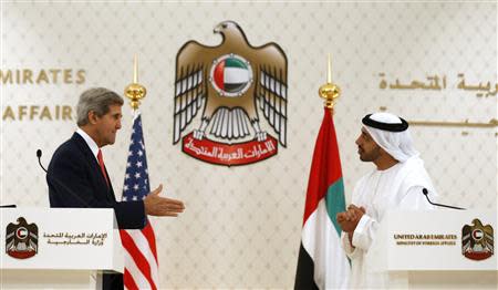 U.S. Secretary of State John Kerry (L) reaches out to shake hands with UAE Foreign Minister Abdullah bin Zayed Al Nahyan at the foreign ministry in Abu Dhabi, November 11, 2013. REUTERS/Jason Reed
