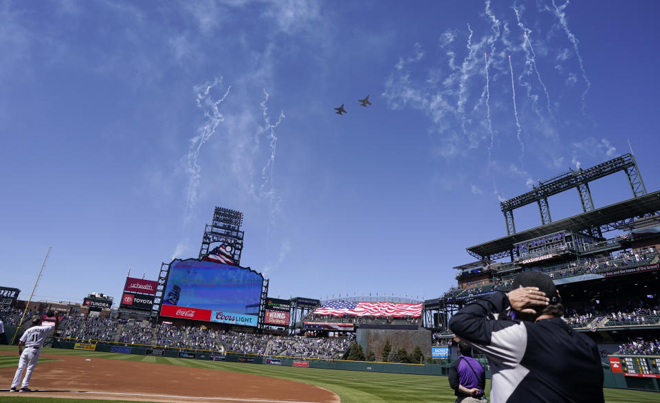 Two F-16 jets from Buckley Air Force Base in Aurora, Colo., fly over Coors Field before a baseball game between the Los Angeles Dodgers and the Colorado Rockies on opening day, Thursday, April 1, 2021, in Denver. The Rockies won 8-5. (AP Photo/David Zalubowski)