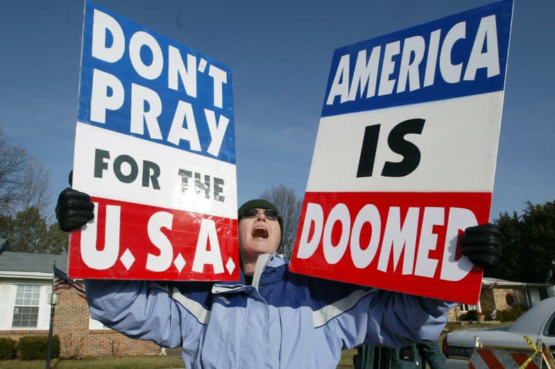 A protester with the Westboro Baptist Church of Topeka, Kan., chants as the funeral procession for U.S. Army Pvt. Peter Navarro pulls up to the St. Clare of Assisi Catholic Church in Ellisville, Mo., on December 23, 2005. On March 2, 2011, the U.S. Supreme Court ruled 8-1 that the anti-gay Kansas church had a constitutional right to stage a peaceful protest at the funeral of a U.S. Marine killed in Iraq. File Photo by Bill Greenblatt/UPI