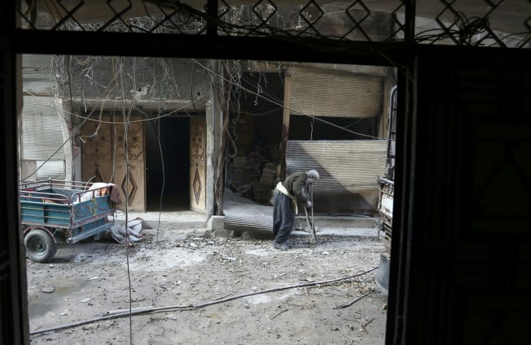 An elderly Syrian man looks for a safe place to take shelter in the Eastern Ghouta region on the outskirts of Damascus during bombardment by government forces on March 14, 2018