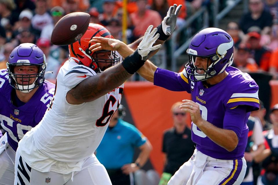 Cincinnati Bengals defensive tackle Josh Tupou (68) pressures Minnesota Vikings quarterback Kirk Cousins (8) as he throws in the fourth quarter during an NFL Week 1 football game, Sunday, Sept. 12, 2021, at Paul Brown Stadium in Cincinnati. Tupou's role will expand due to DJ Reader's knee injury.