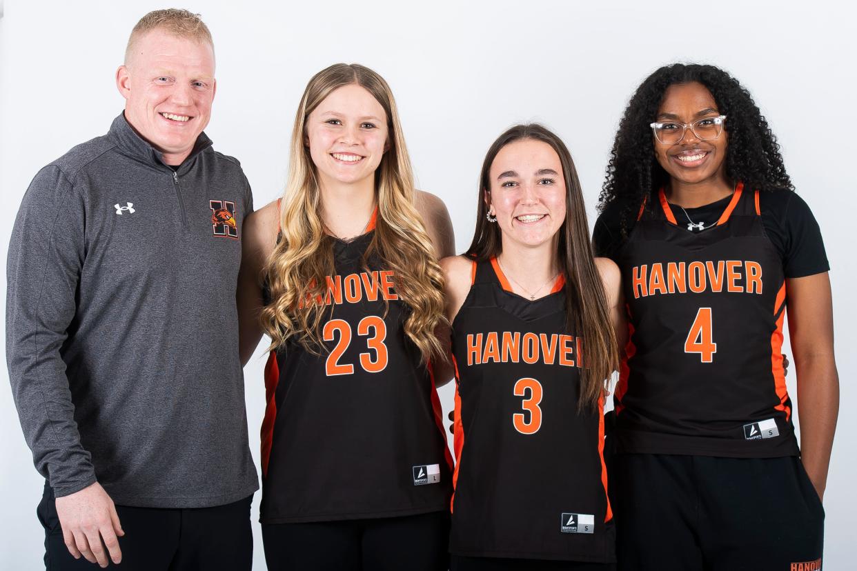 (From left) Hanover basketball head coach Zac Carrick poses for a photo with players Riley Stigler, Peyton Conover and Alanys Perez Beltran during YAIAA winter sports media days Thursday, November 9, 2023, in York.