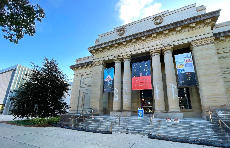 "GIFT" is an experimental work by Cannupa Hanska Luger at the U-M Museum of Art.  In September, Luger painted the letters G, I, F, and T on the four front columns of the museum building in white porcelain clay slip, a liquid clay mix.