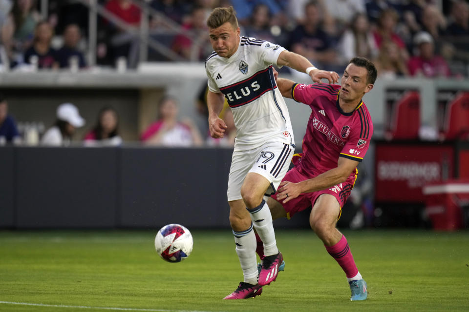 Vancouver Whitecaps' Julian Gressel (19) and St. Louis City's Kyle Hiebert (22) challenge for the ball during the first half of an MLS soccer match Saturday, May 27, 2023, in St. Louis. (AP Photo/Jeff Roberson)